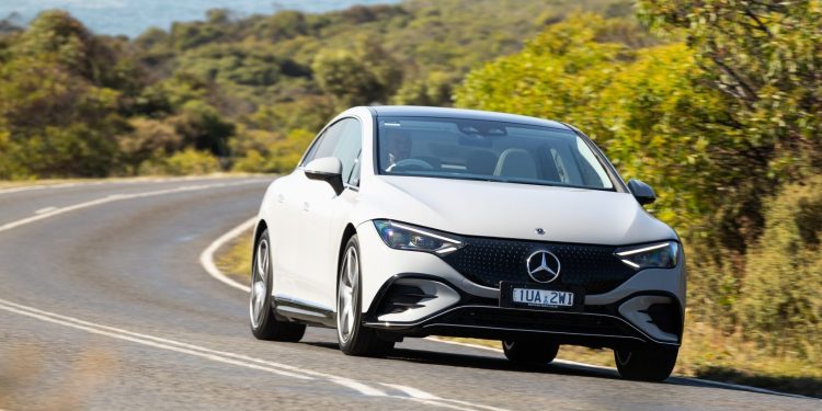 Mercedes-Benz EQE 350 4Matic+ driving along coastal road