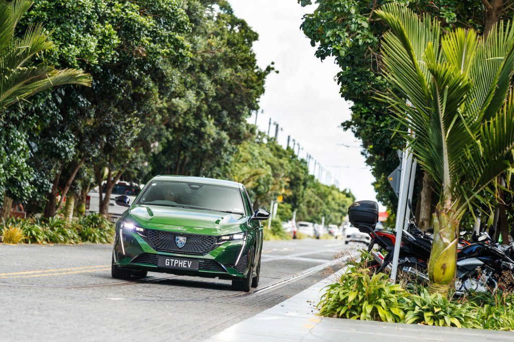 The new Peugeot 308 GT PHEV driving in suburbia