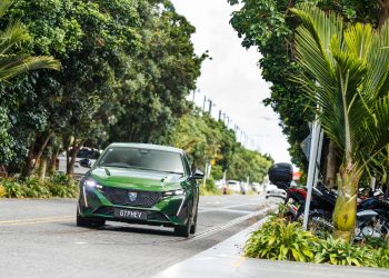 The new Peugeot 308 GT PHEV driving in suburbia