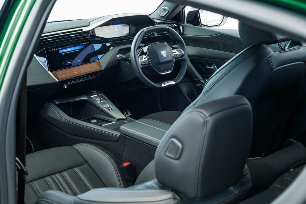 Interior of the Peugeot 308 GT PHEV, showing steering wheel and infotainment system
