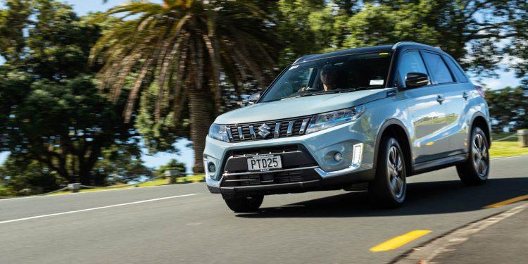 Blue Suzuki Vitara Hybrid taking a corner