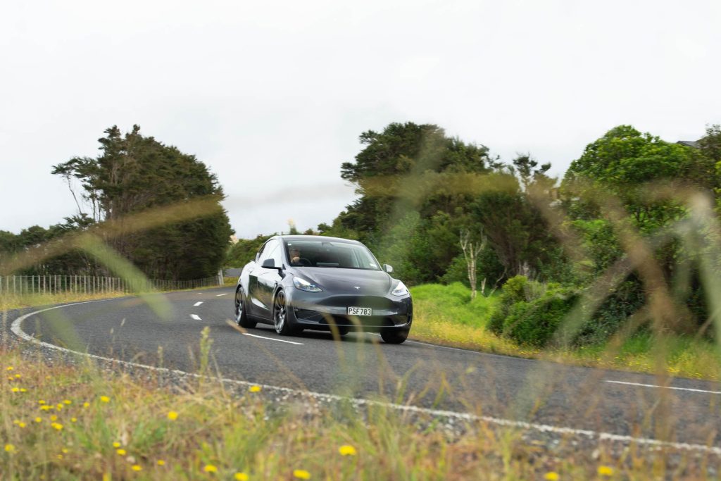 Tesla Model Y takes a corner on a backroad