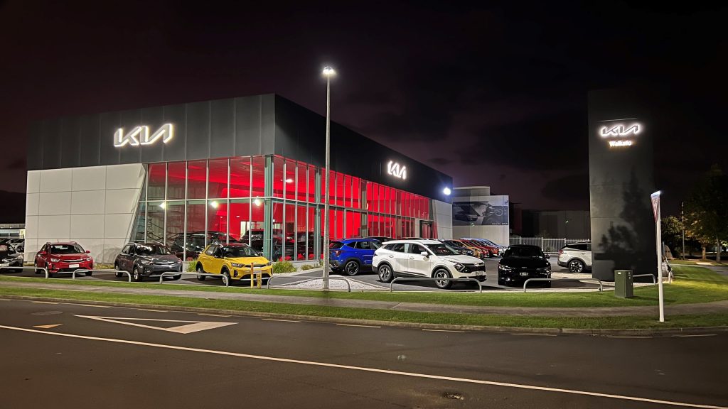 Cars outside of new Kia Hamilton dealership at night