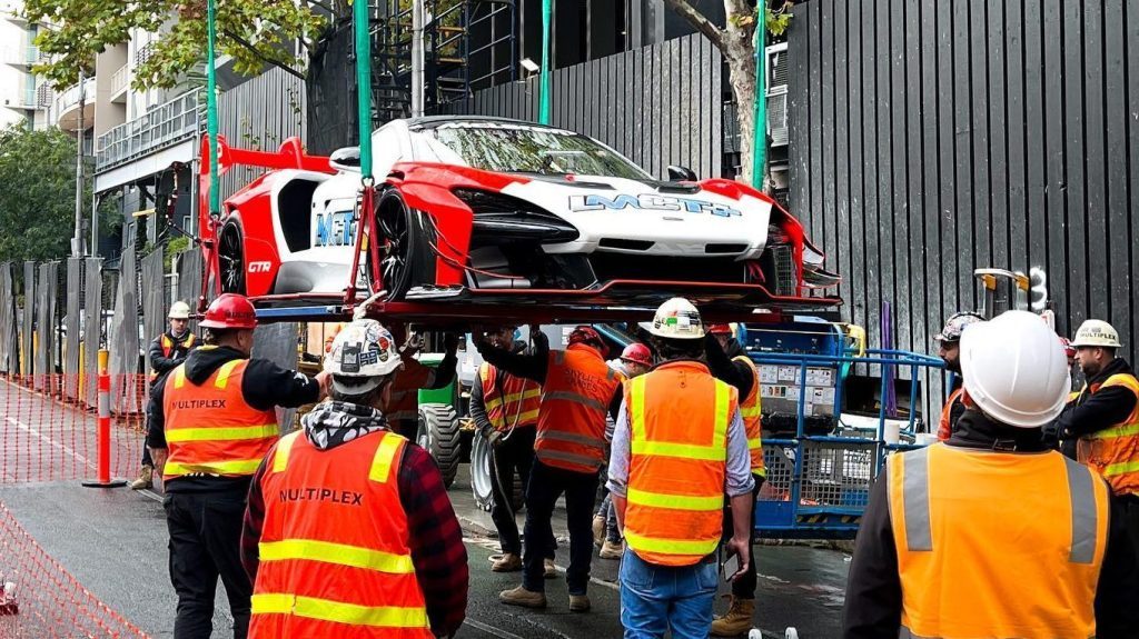 McLaren Senna GTR being hoisted into air by crane