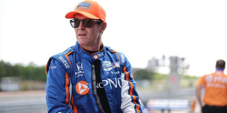 Scott Dixon sitting on pit wall