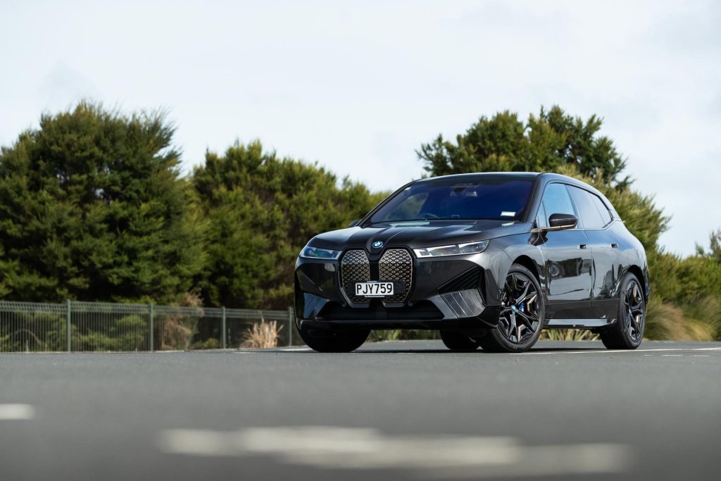 BMW iX M60 parked in a carpark from a front quarter angle