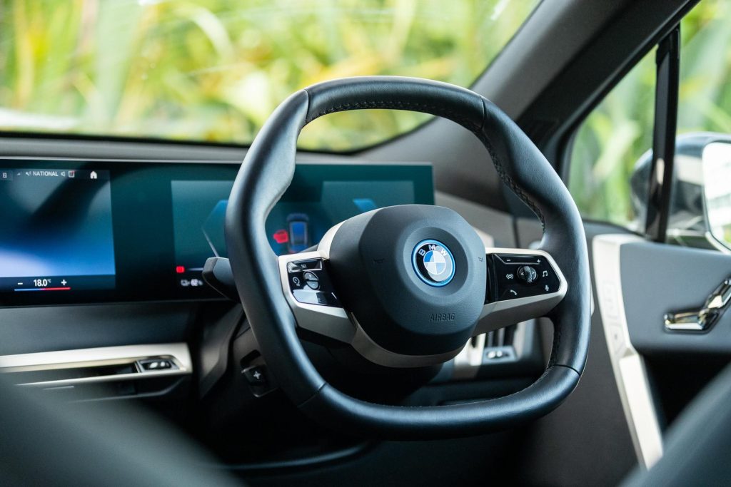 Shaped steering wheel of the BMW iX M60, with driver's display behind it