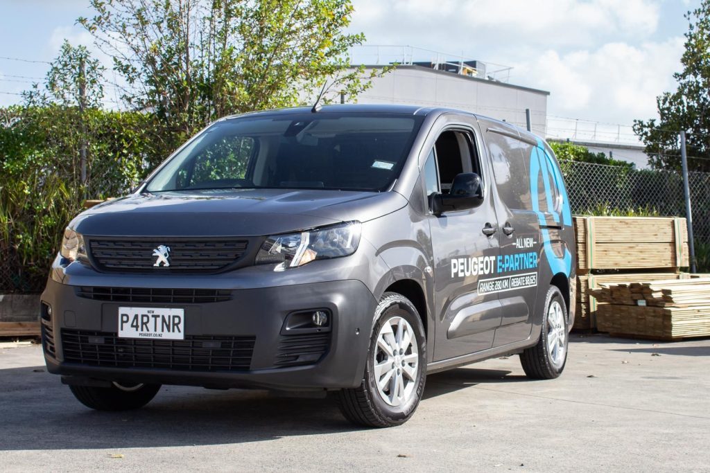 Peugeot e Partner Van with wood ready to be loaded behind it