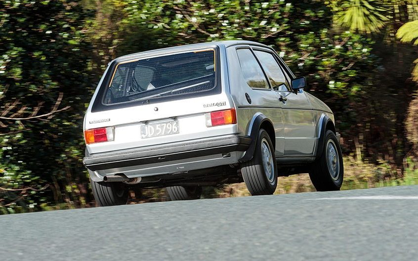 Old Volkswagen Golf driving around corner