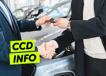 Man handing man car keys while shaking hands