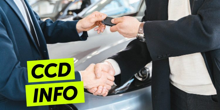 Man handing man car keys while shaking hands