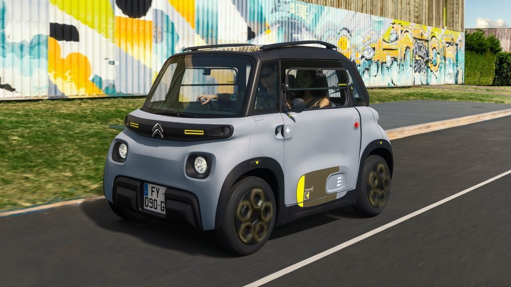 Citroen Ami driving next to art wall