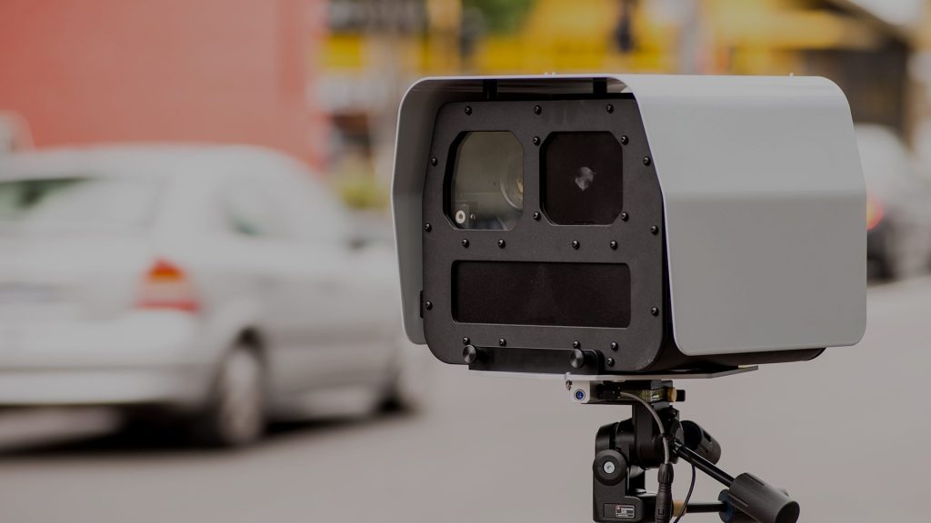 Speed camera pointing at cars on road