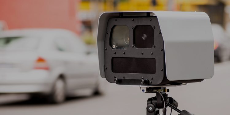 Speed camera pointing at cars on road