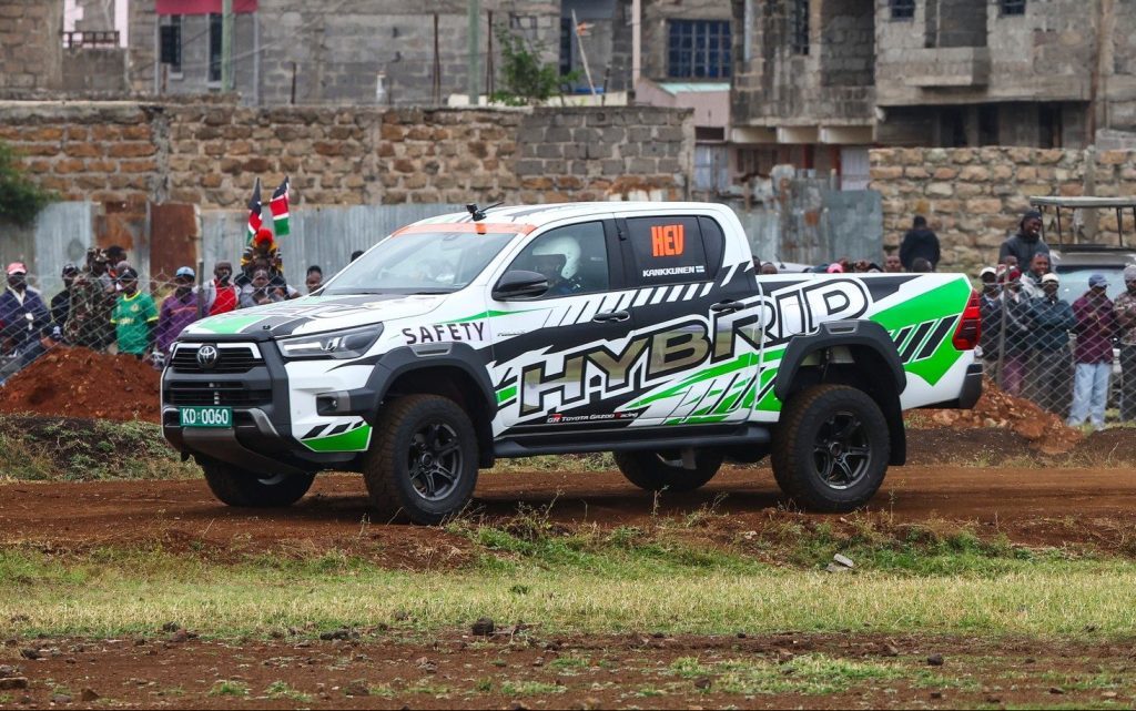 Toyota Hilux hybrid driving on dirt road in Africa