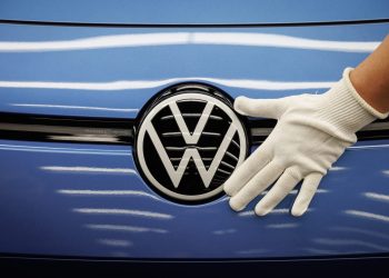 Person putting hand on Volkswagen badge
