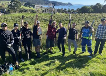 Team of people from GM NZ and Isuzu Trucks holding shovels