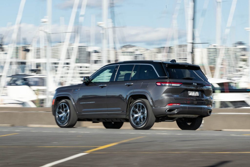 Jeep Grand Cherokee 4xE Summit Reserve action shot showing the rear