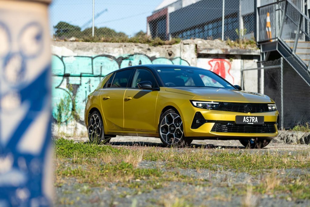 Front quarter shot of the Opel Astra SRi with graffiti in the background