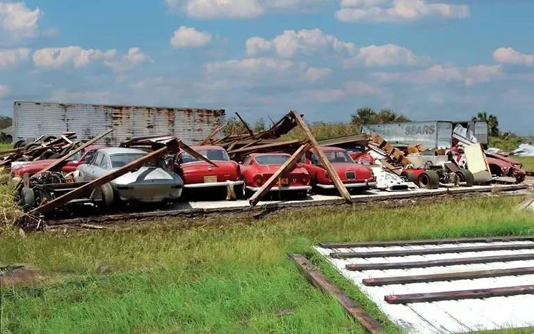 Classic Ferraris sitting under fallen barn