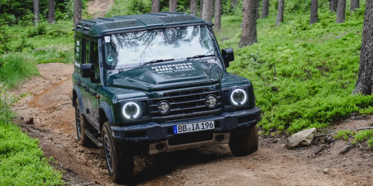 Hydrogen fuel cell Ineos Grenadier driving through forest