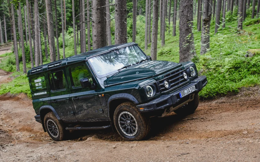 Hydrogen fuel cell Ineos Grenadier driving through forest