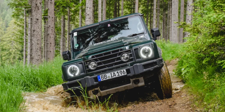 Hydrogen fuel cell Ineos Grenadier driving through mud puddle