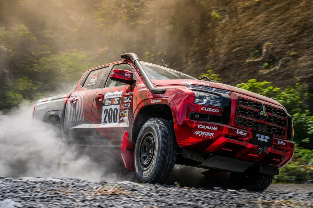 Mitsubishi Triton rally car drifting on gravel