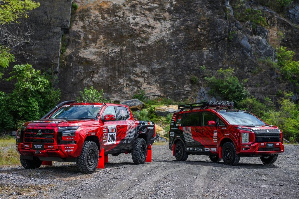 Mitsubishi Triton rally car parked next to Delica D:5 support vehicle