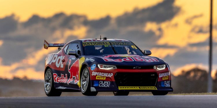 Shane van Gisbergn racing Chevrolet Camaro Supercar in Sydney during sunset