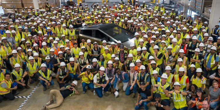 First production Tesla Cybertruck surrounded by employees