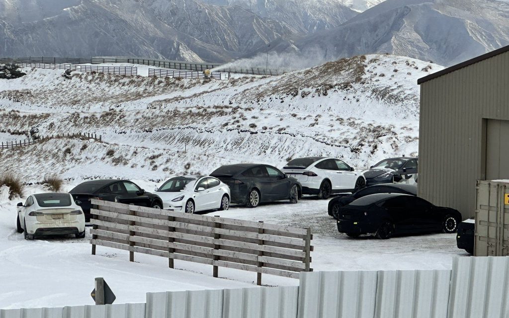 Tesla S3XY range parked outside of warehouse in snow