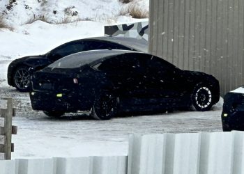 Tesla Model 3 Project Highland parked outside of warehouse in snow
