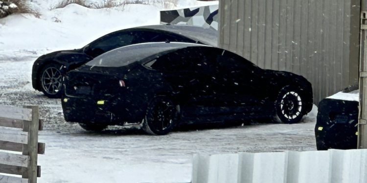 Tesla Model 3 Project Highland parked outside of warehouse in snow