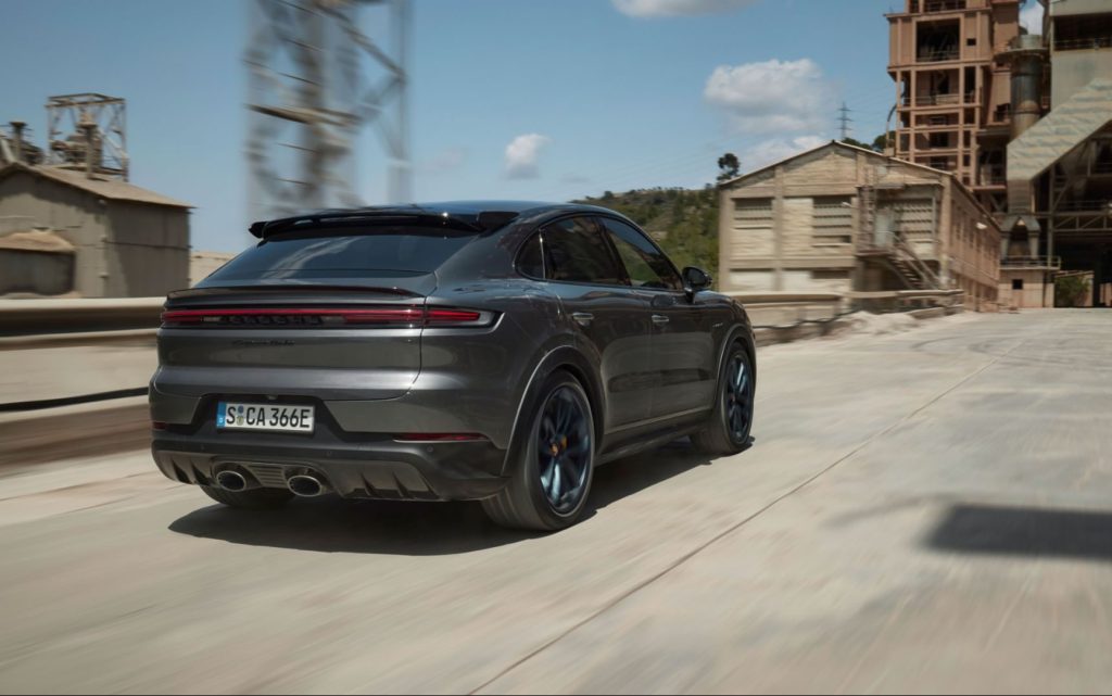 Porsche Cayenne Turbo E-Hybrid Coupe driving through old factory