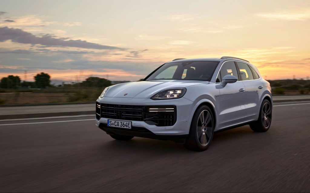 Porsche Cayenne Turbo E-Hybrid SUV driving on road during sunset