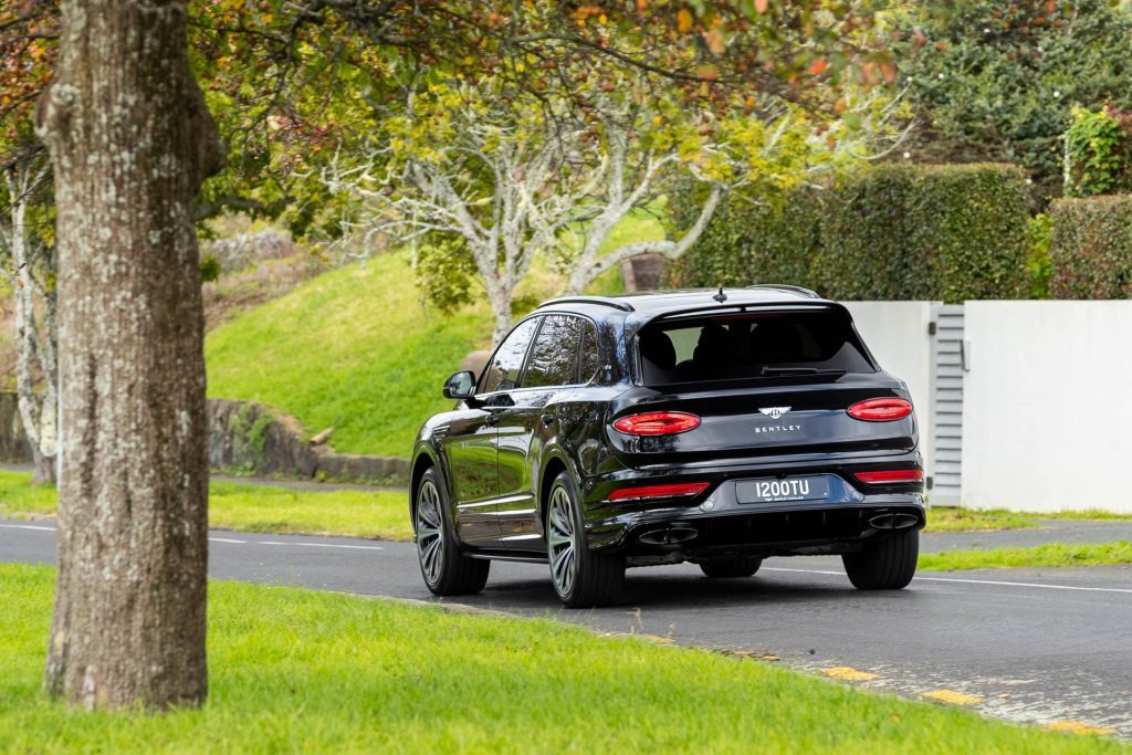 Rear shot of Bentley Bentayga EWB driving past on a quiet road