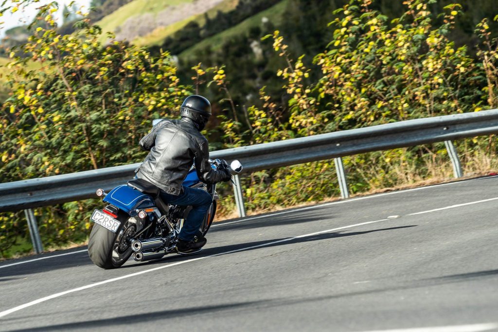 Harley-Davidson Fat Boy 114 takes a corner, showing rear of bike