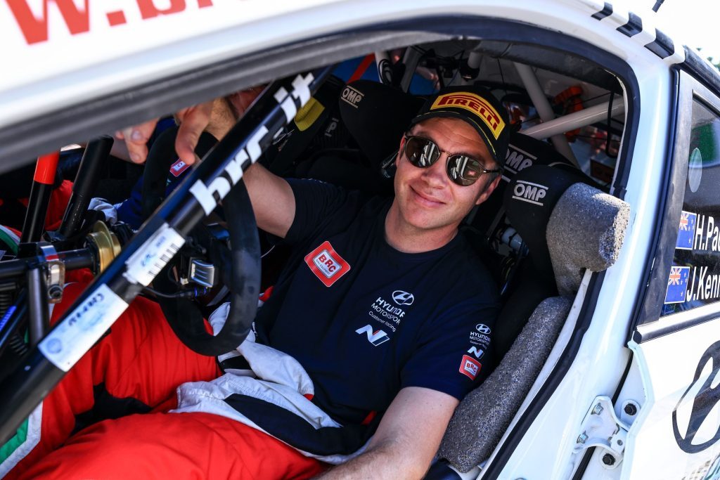 Hayden Paddon sitting in Hyundai i20 rally car