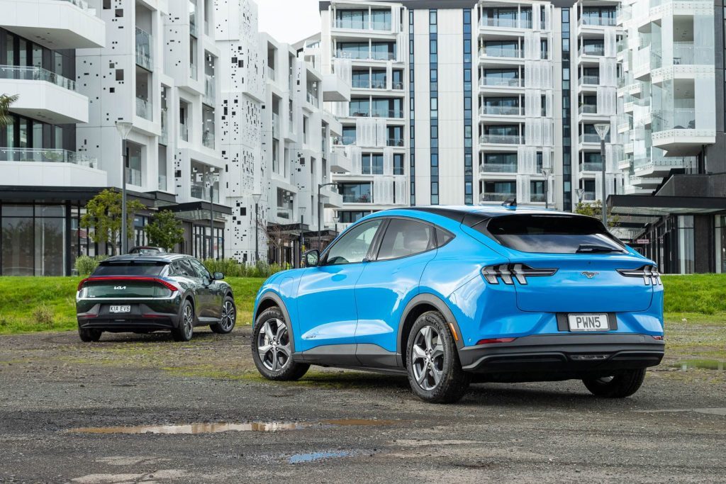 Ford Mustang Mach-E rear, next to Kia EV6 Long Range