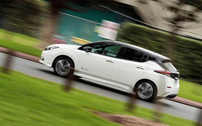 Nissan Leaf driving past park