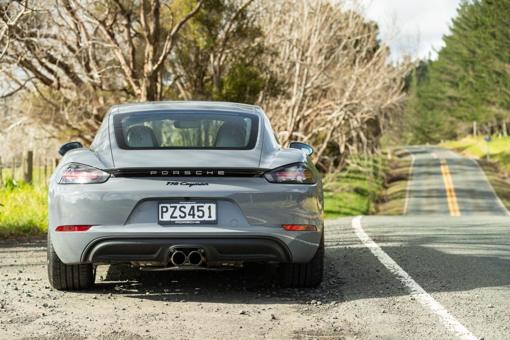 Porsche 718 Cayman rear view, parked on the side