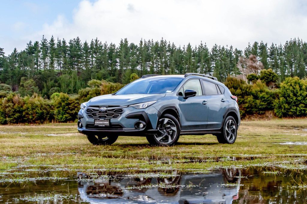 Subaru Crosstrek front quarter shot, in front of a large puddle