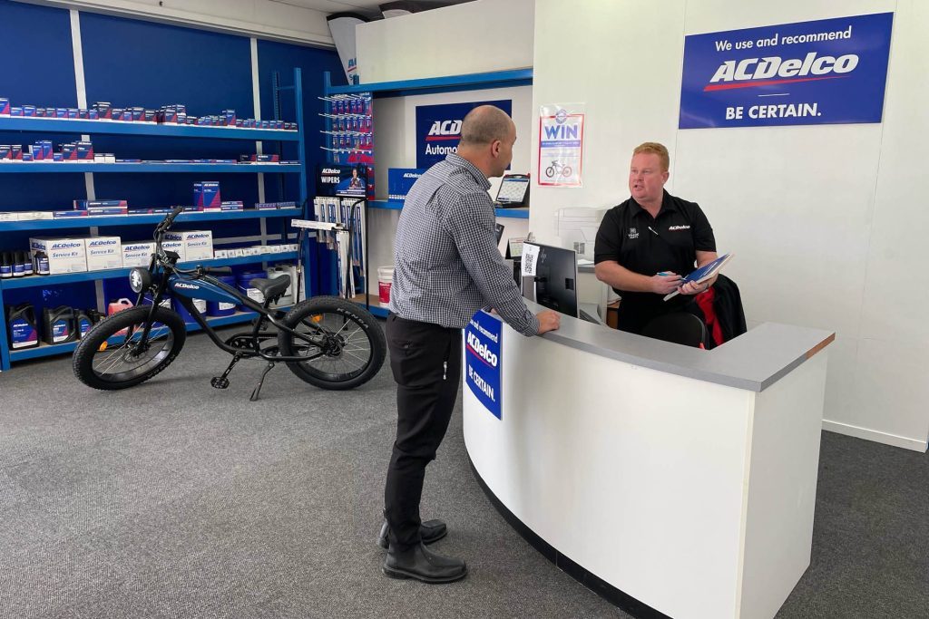 Men talking over counter at ACDelco Whakatane