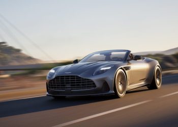 Aston Martin DB12 Volante with roof down driving on road