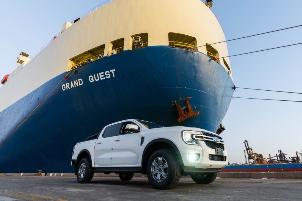 Ford Ranger parked next to ship