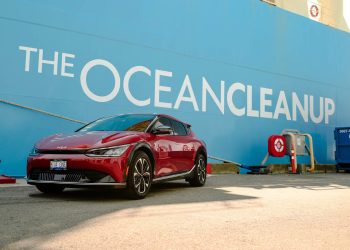 Kia EV6 parked next to The Ocean Cleanup ship