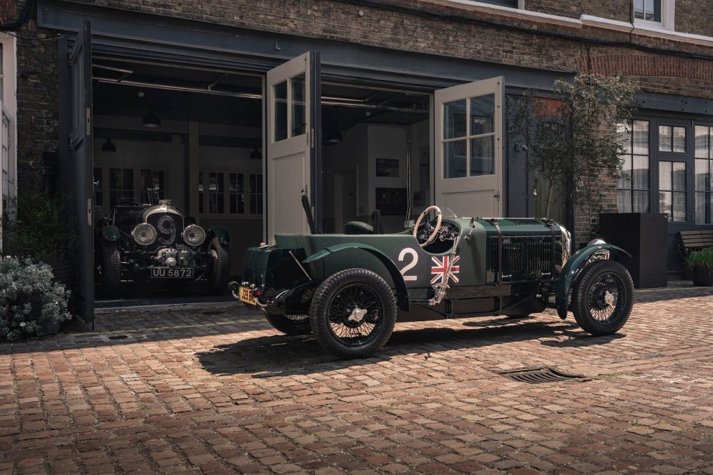 Bentley Blower Jnr parked in front of garages with original car