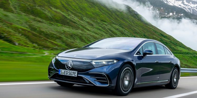 Mercedes-Benz EQS 450 4Matic driving on road in mountains