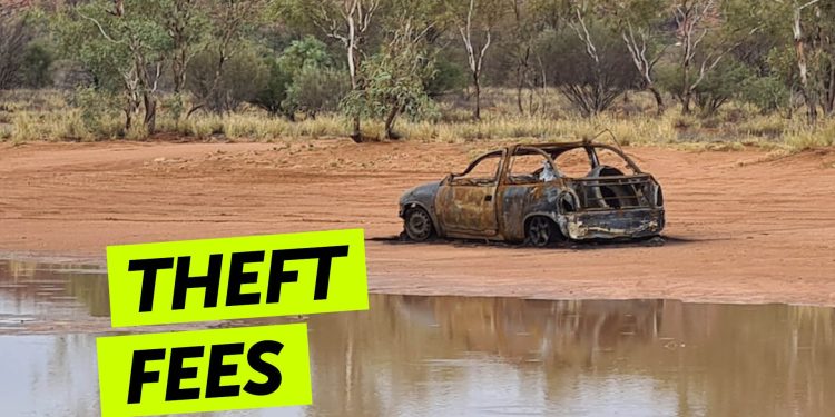 Burnt out car by lake